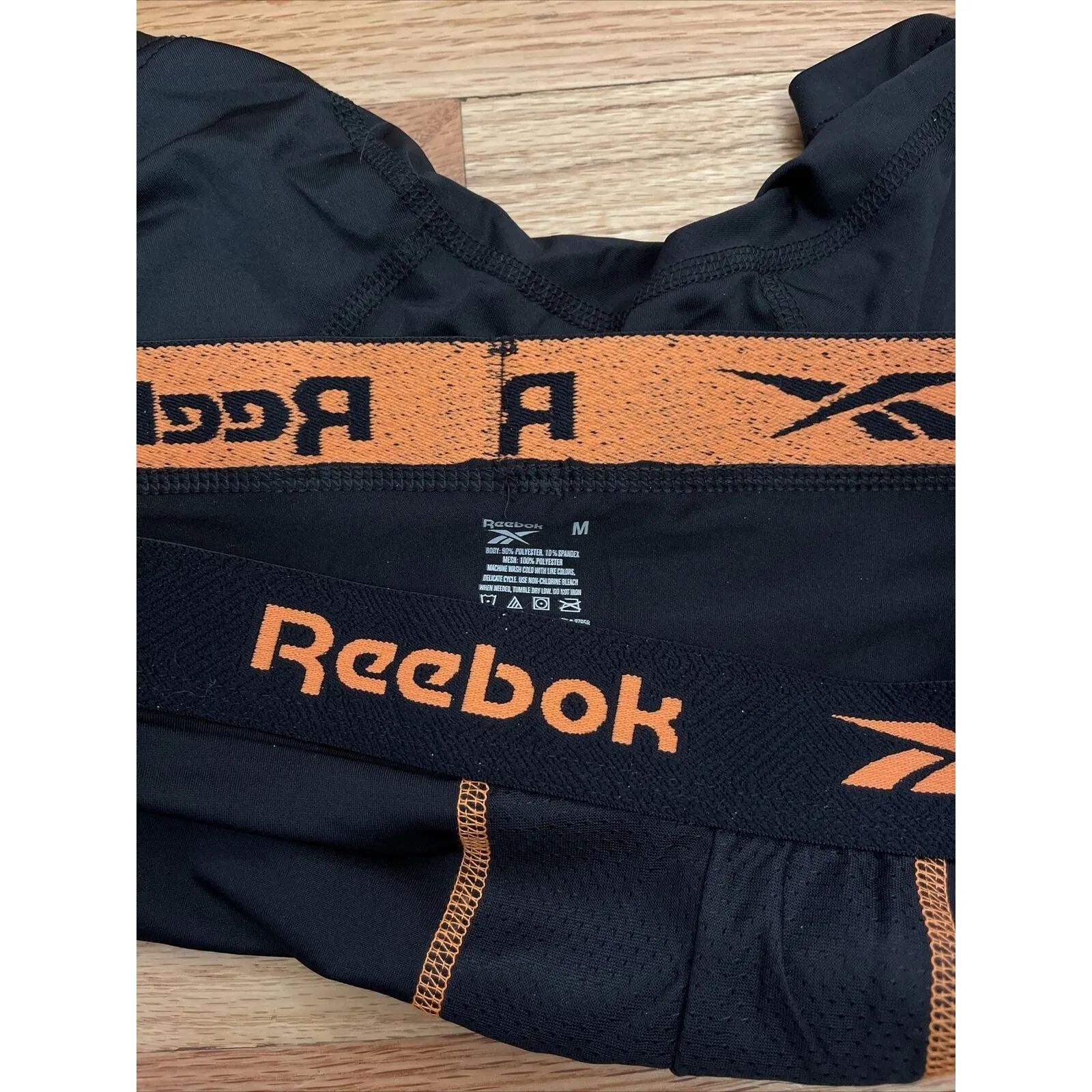 Men's Reebok black medium compression shorts orange band